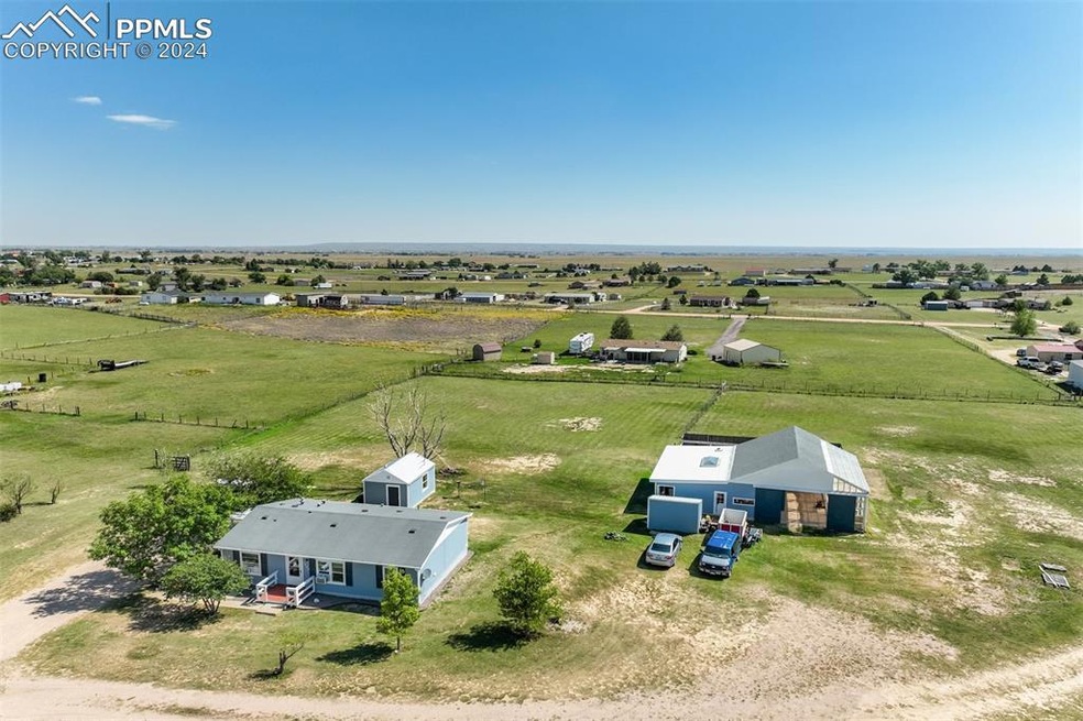 Birds eye view of property with a rural view