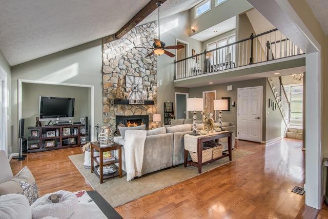 The Colorado lodge feel carries inside. Vaulted living room with open feel and beam ceiling is anchored by floor to ceiling stone wood burning fireplace.