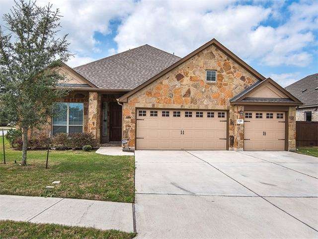 Wonderful curb appeal with those barn style garage