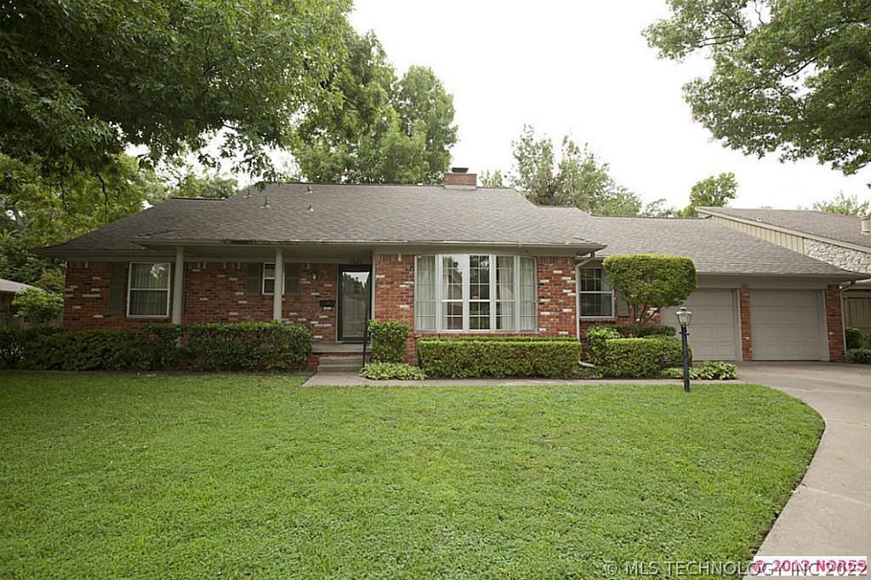 One-level, full brick home on wooded lot in excell