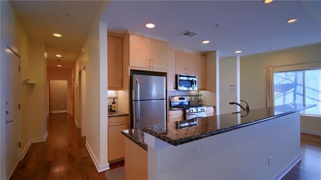 Hallway to bedrooms with door on the left being ba