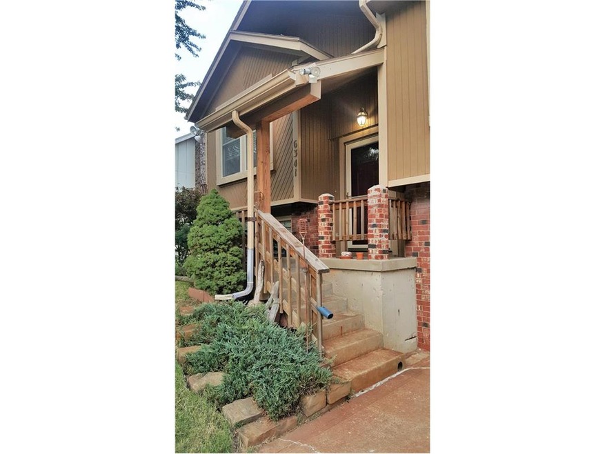 The entry is enhanced by a covered front porch.