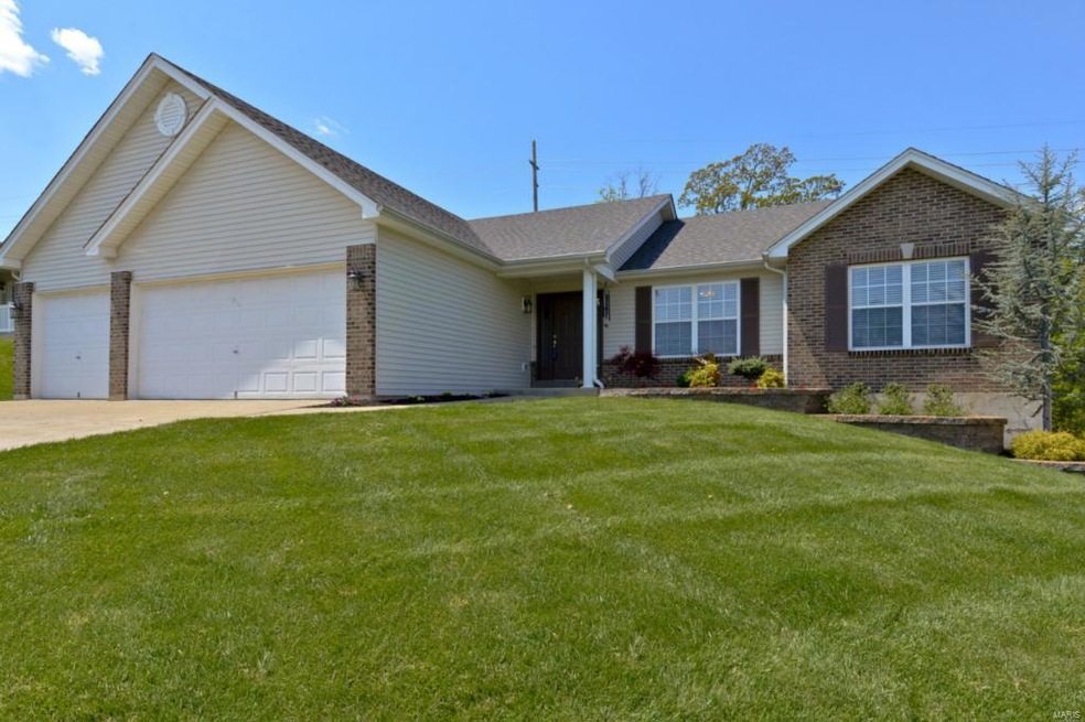 Pristine landscaping, covered porch and brick and 