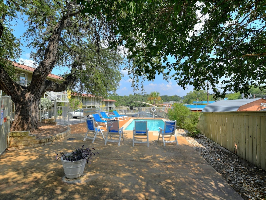 View of pool featuring a fenced backyard and a pa