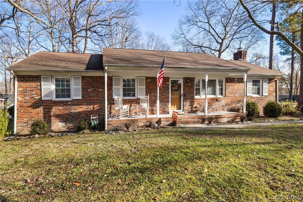 Ranch-style home with a porch and a front lawn