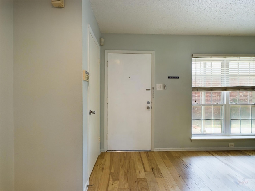 Entryway with baseboards and light wood-style flo