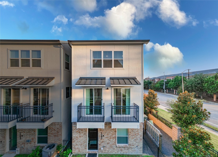 Modern townhome with a brick and stucco exterior,