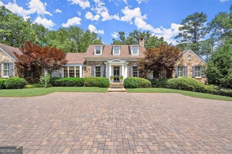 Front view with paver parking for an additional 4 