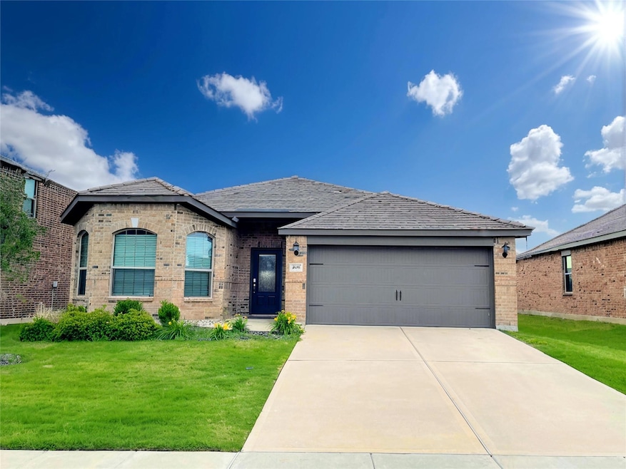 View of front of property with a front yard, an at