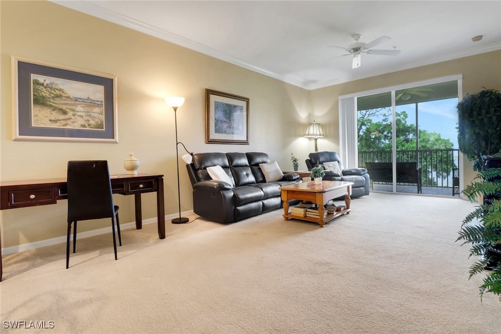 Living area featuring light colored carpet, crown