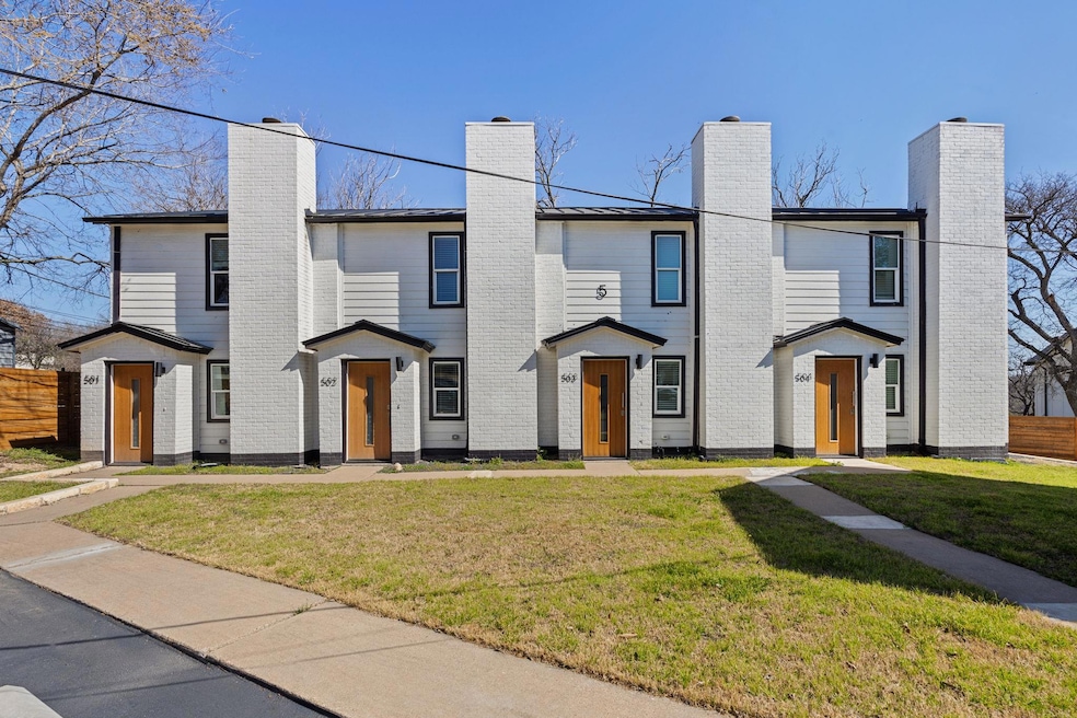 Multi unit property featuring a chimney, fence, a