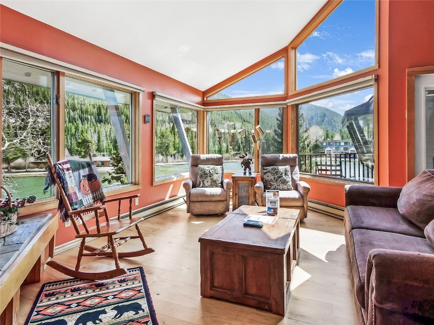 Sunroom / solarium featuring baseboard heating, a