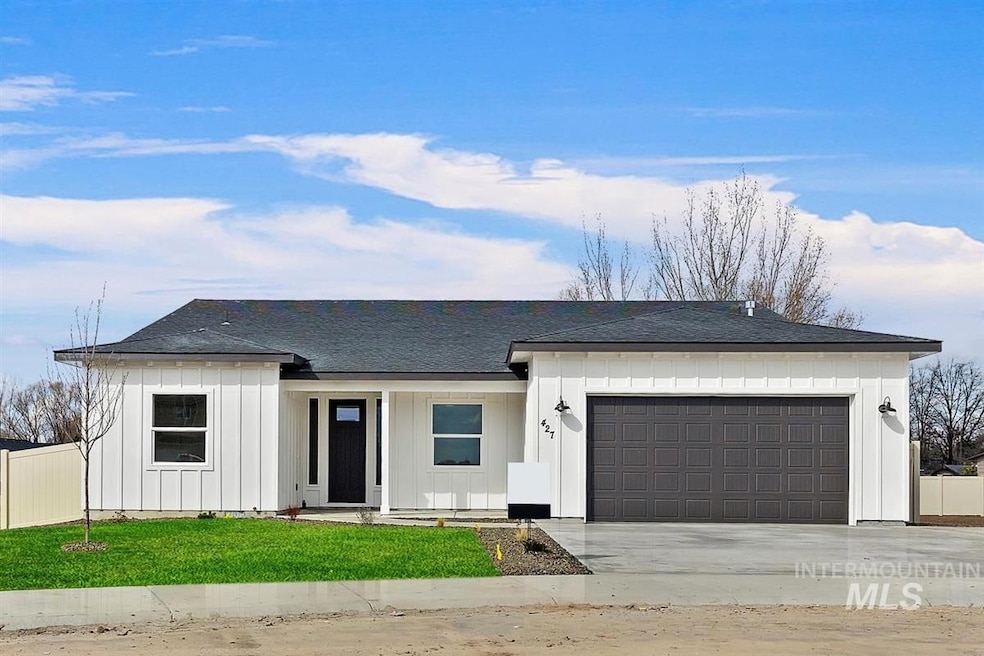 View of front of property featuring board and batten siding, a garage, concrete driveway, and a shingled roof