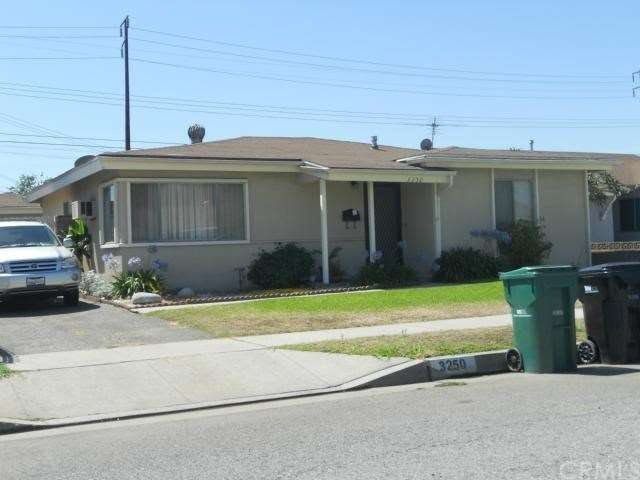 Front of property with long driveway with two-car 