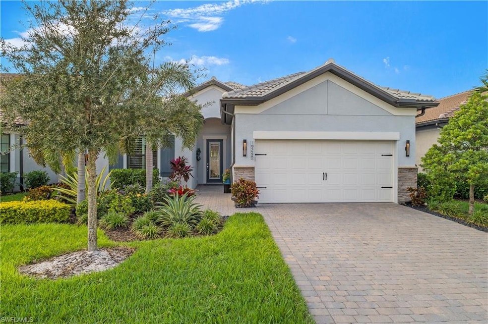 Gorgeous Summerwood floor plan with beautiful stone and stucco exterior, wide and welcoming entryway, and professional landscaping for excellent curb appeal.