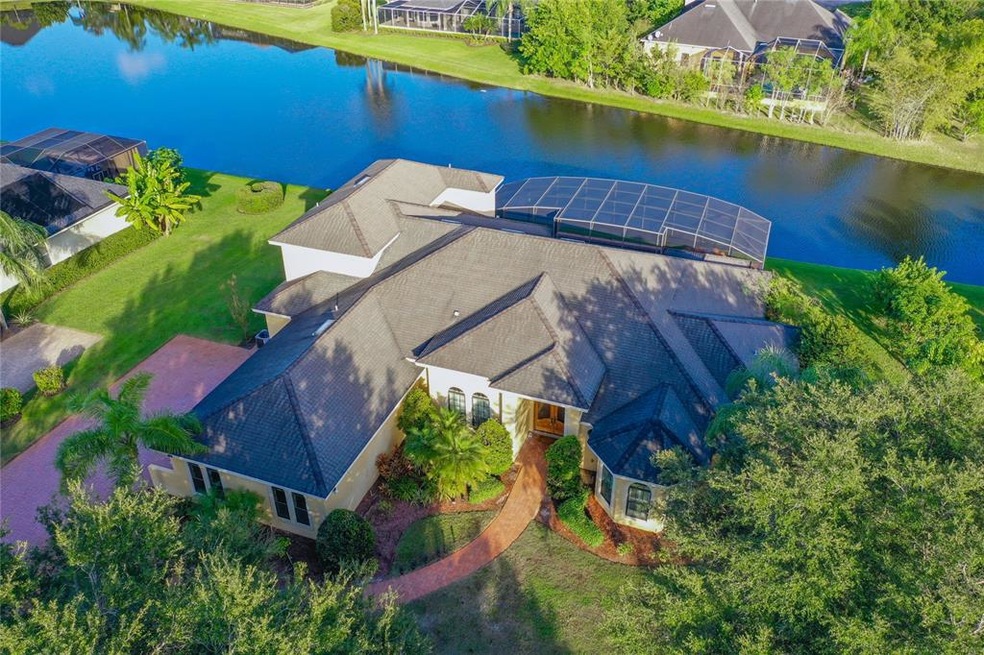 Aerial Front View of Home on Pond