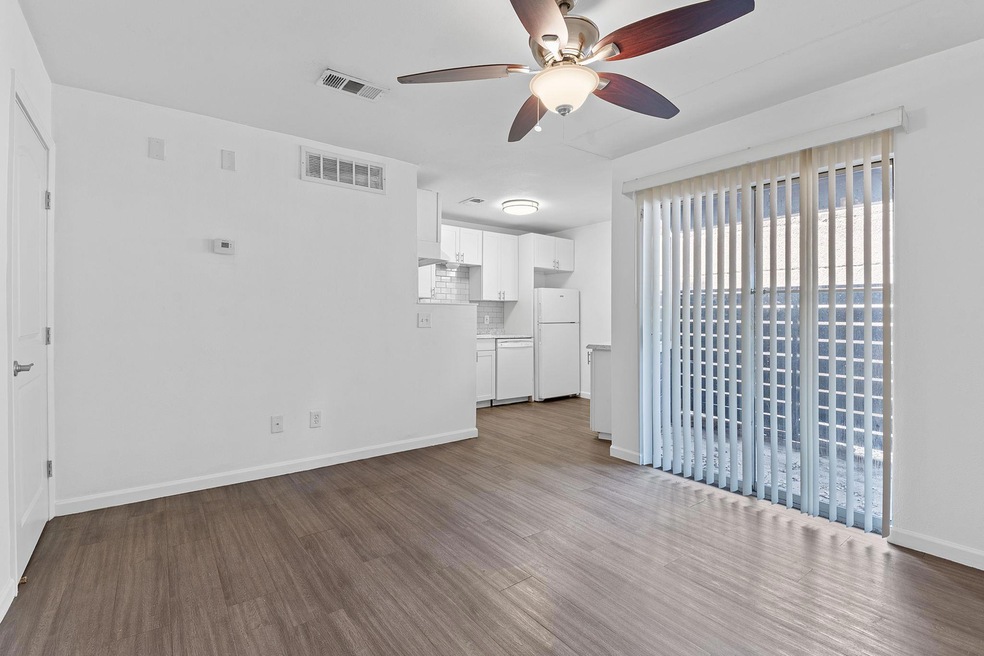 Unfurnished living room with a ceiling fan, wood 