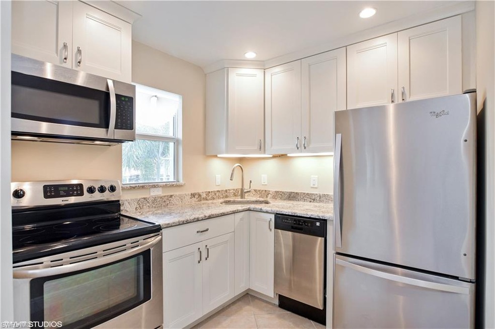 New open kitchen with granite countertops and stai