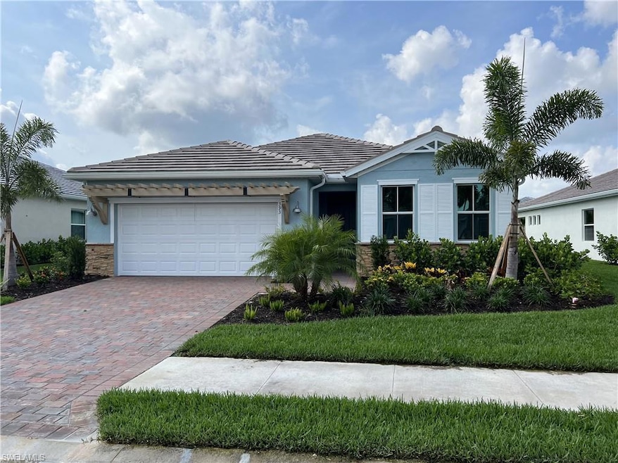 Ranch-style home with decorative driveway, an atta