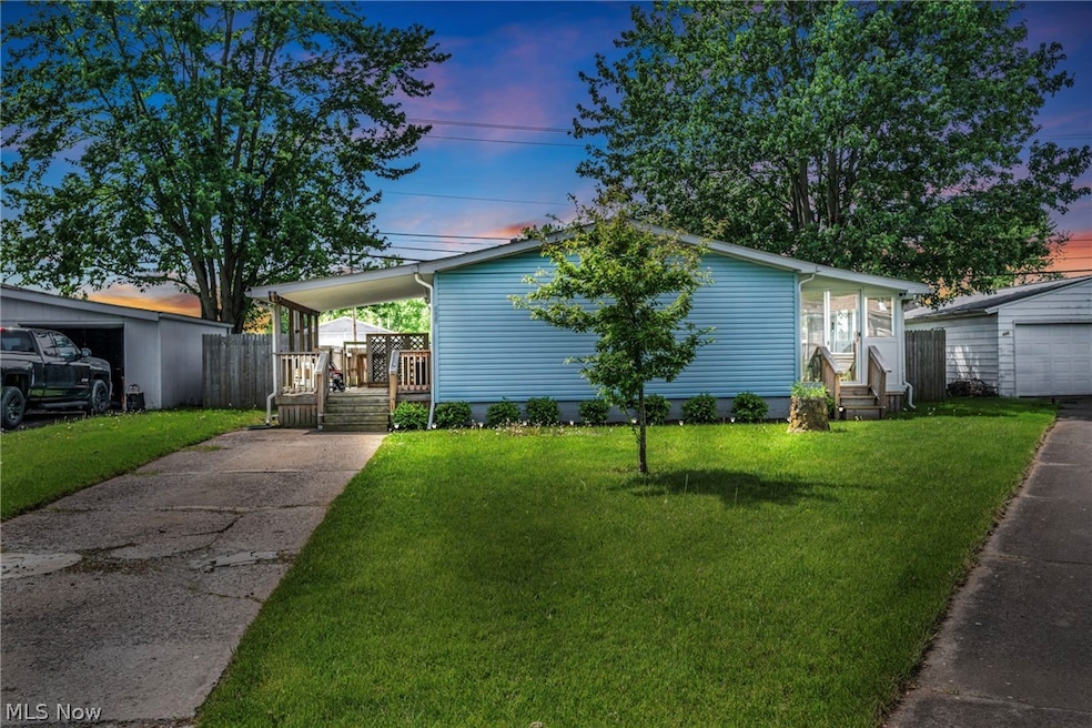 View of front of property featuring a garage and a lawn
