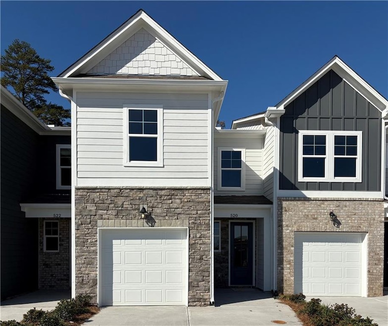 Craftsman-style house with an attached garage, driveway, and board and batten siding