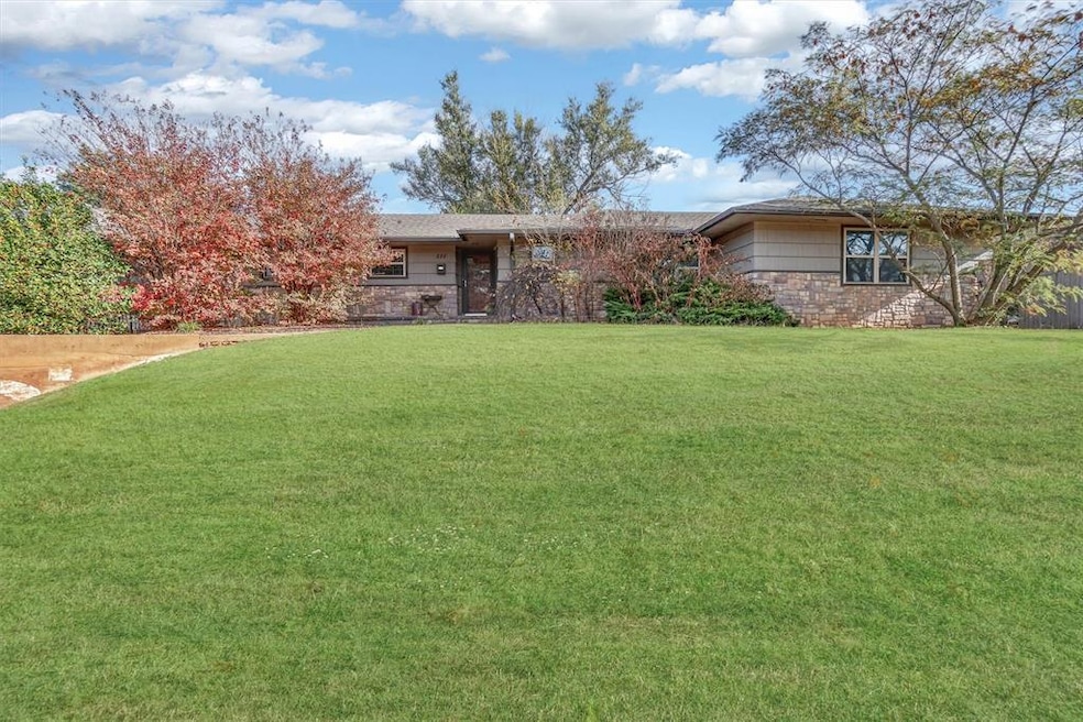 View of front facade with a front yard and stone siding