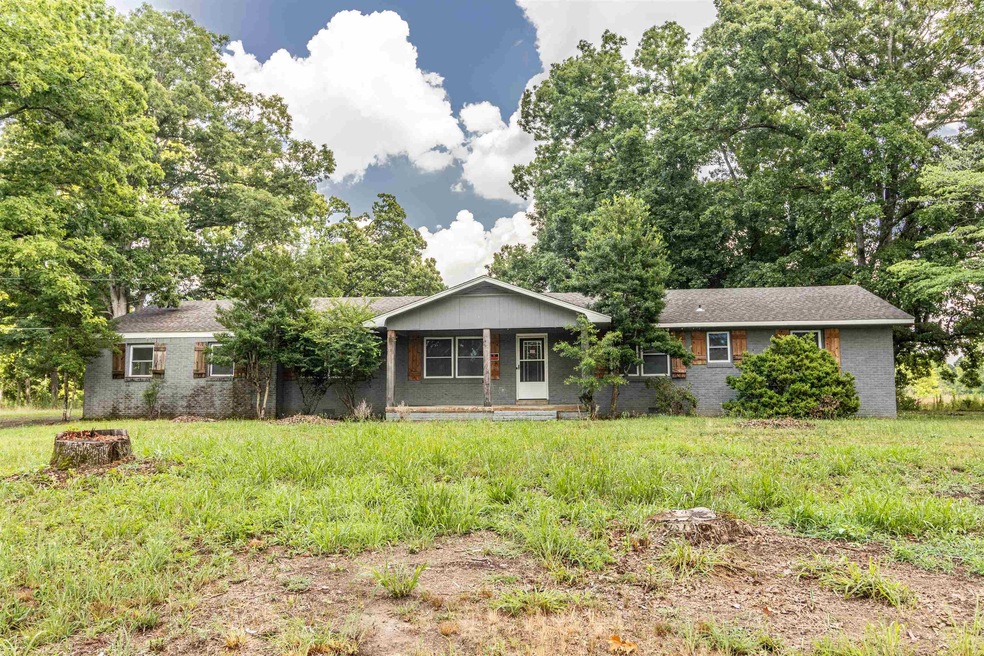 Ranch-style home featuring a front lawn