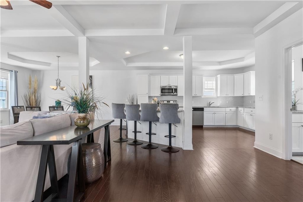 Kitchen featuring dark wood-style flooring, tastef