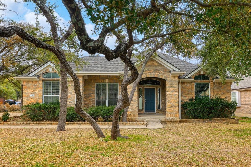 View of front of property featuring roof with shi