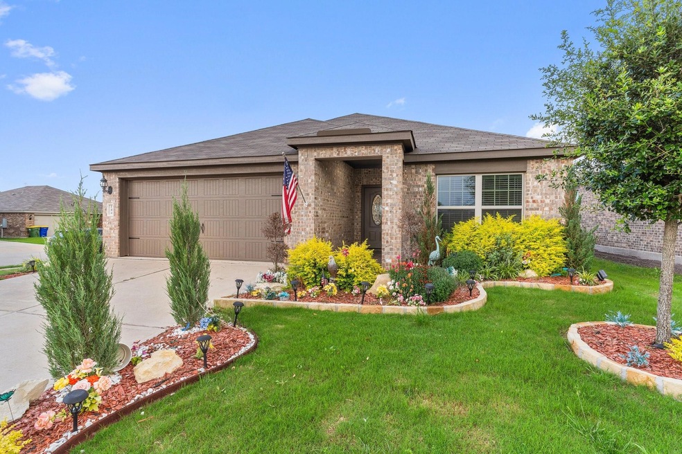 Prairie-style home with a garage and a front yard