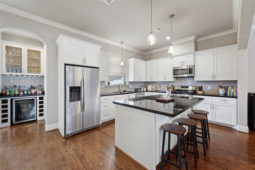 The kitchen is equipped with a refrigerator, micro