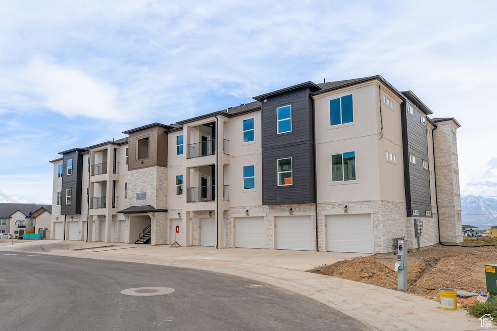 View of building exterior with a residential view and driveway