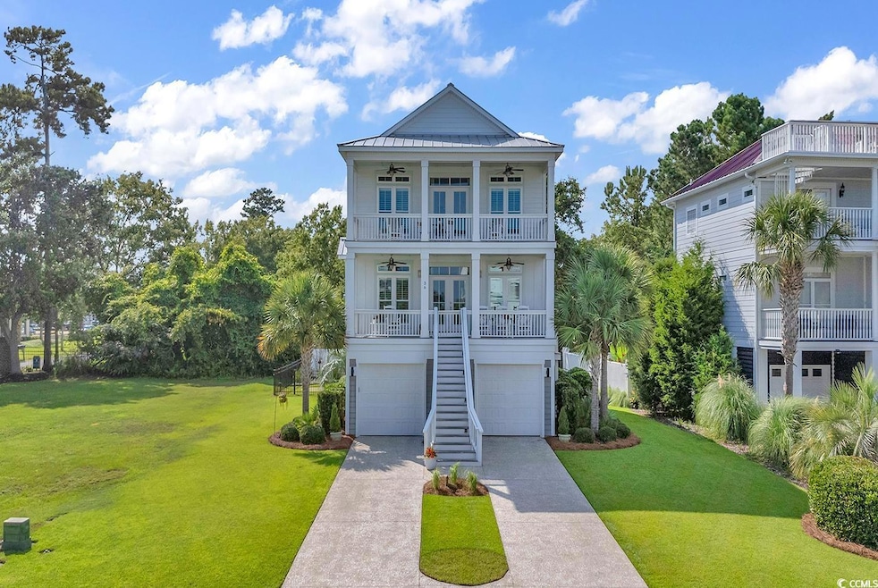 Coastal inspired home featuring a balcony, a porch