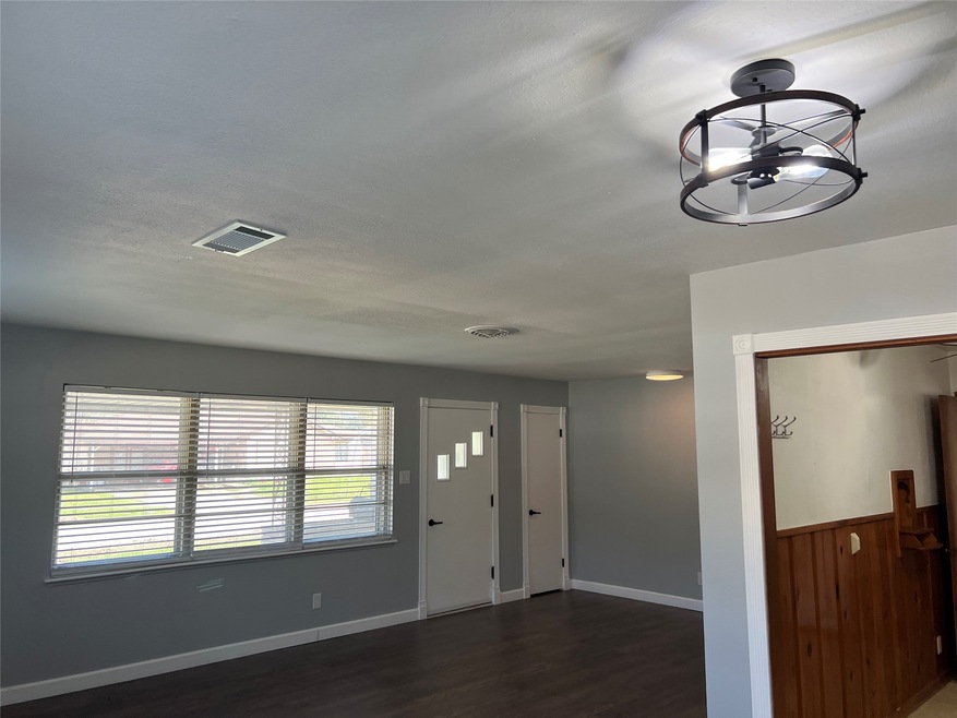 This room features modern lighting, large windows
