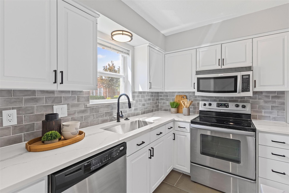 Kitchen featuring tile patterned flooring, white c
