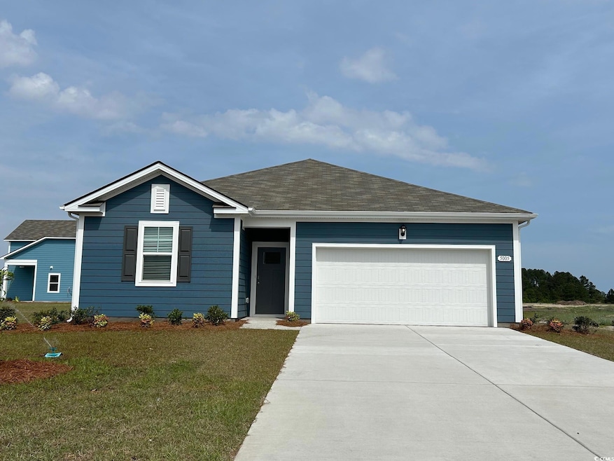Single story home featuring concrete driveway, roo