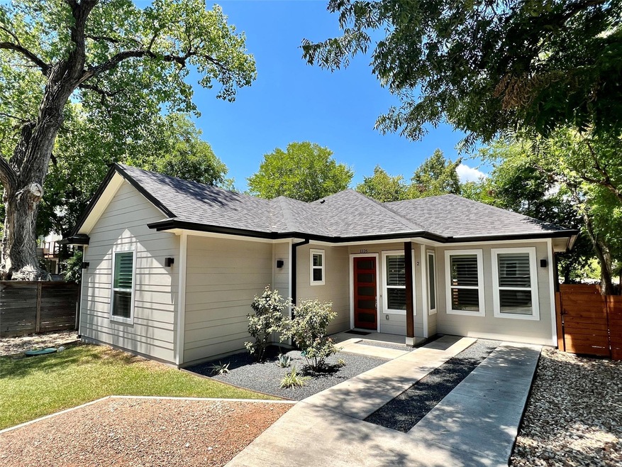View of front of property featuring a shingled ro