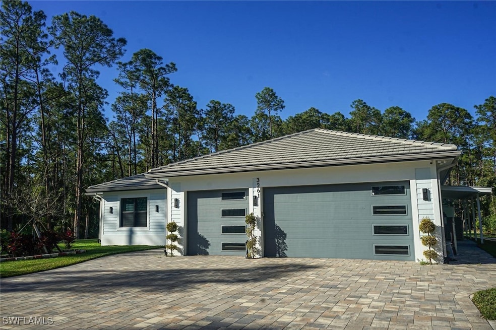 View of front of home featuring a garage, decorati