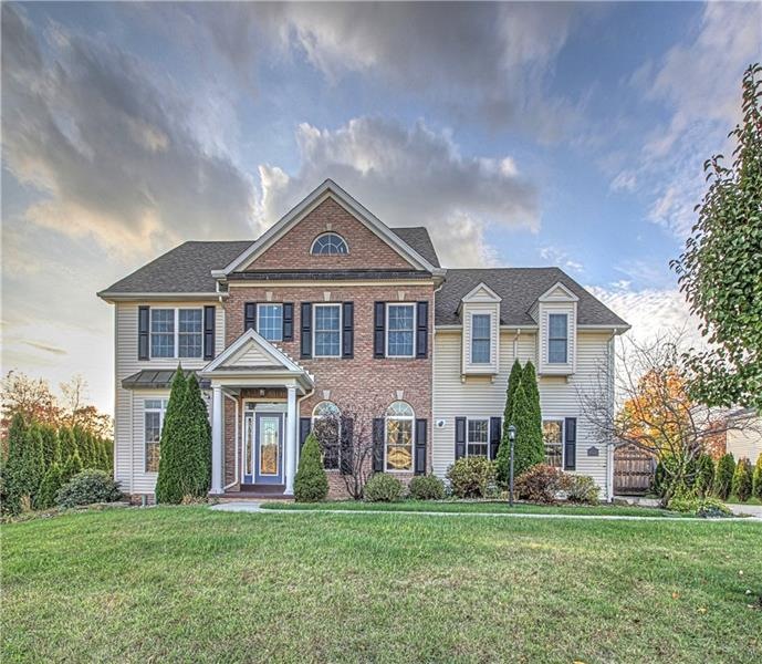 Appealing brick/vinyl custom built home on a premi