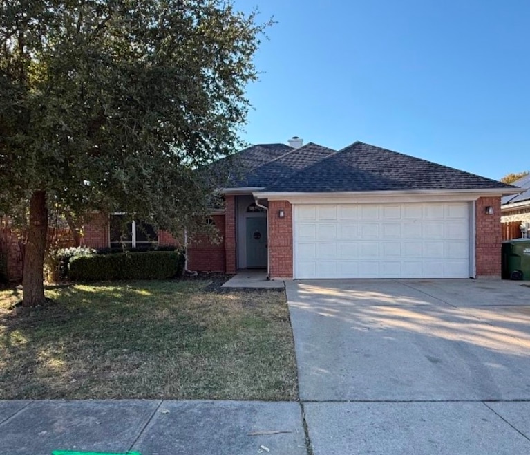 Ranch-style home featuring driveway, a front lawn, brick siding, and roof with shingles