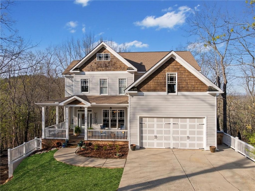 View of front of property with side fence, a garag