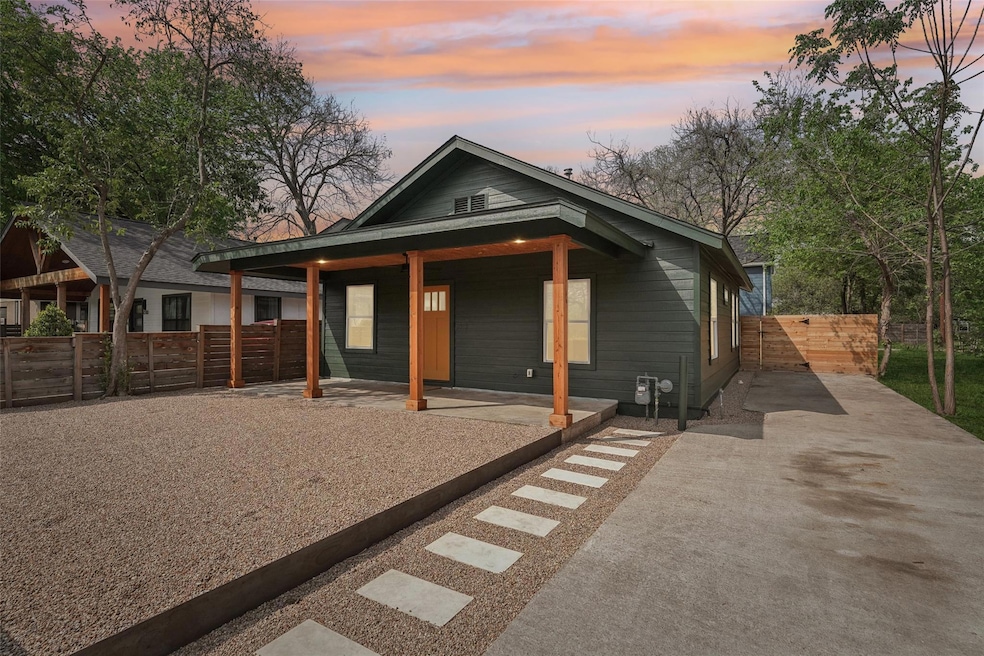 View of front of property with fence, covered por