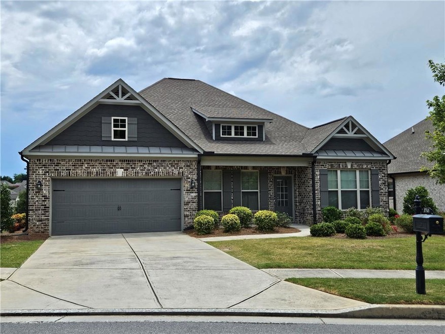 Craftsman-style home with a garage and a front law