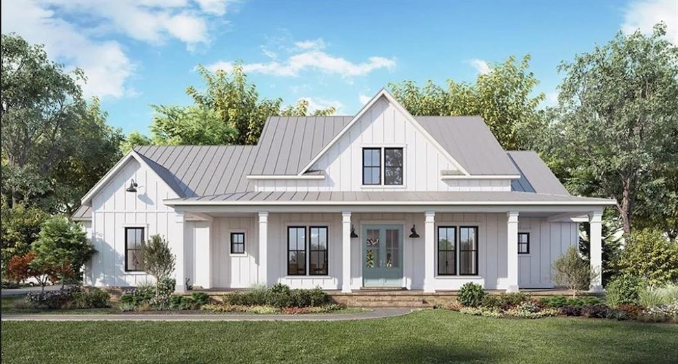 Modern inspired farmhouse with board and batten siding, covered porch, and a front lawn