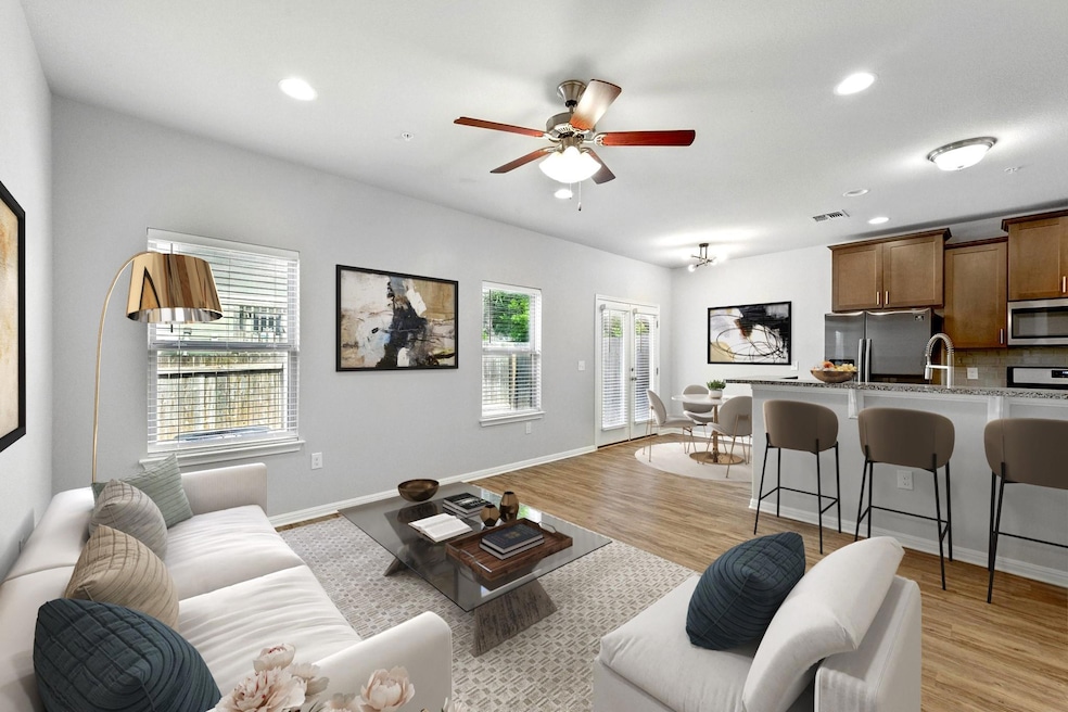 Living area featuring a ceiling fan, recessed lig