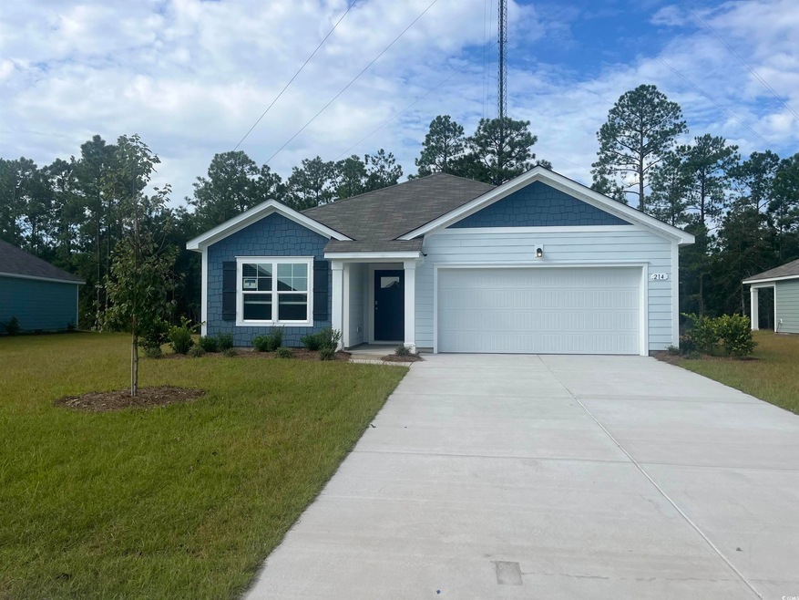 Ranch-style home with a front yard and a garage