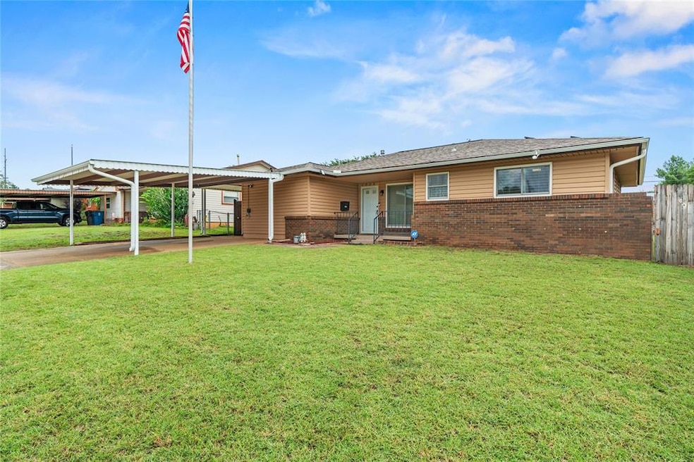 Single story home with brick siding and an attached carport