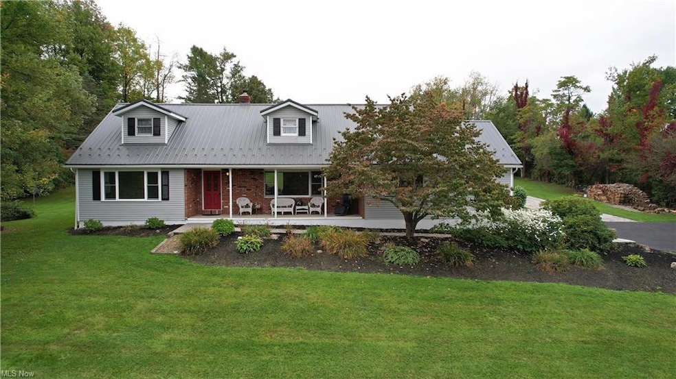 Cape cod-style house featuring a front lawn and a 