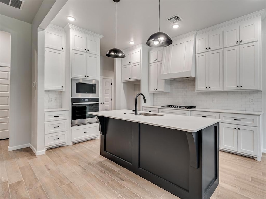 Kitchen featuring custom exhaust hood, a center is