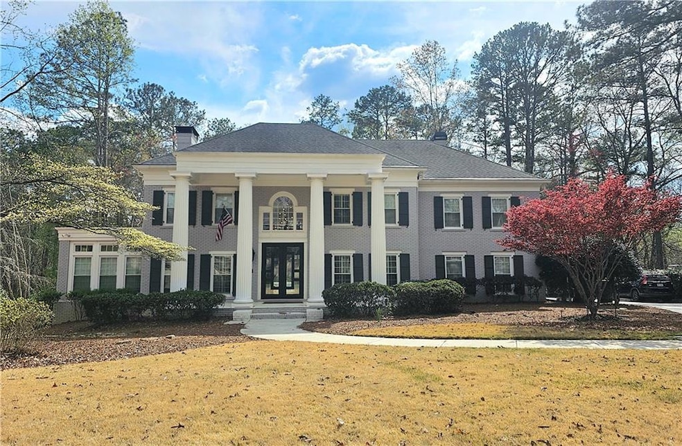 Neoclassical home featuring a front yard